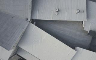 Business owner reviewing commercial roof maintenance contract with technician—get proactive with annual roofing care to protect your property and budget wisely.