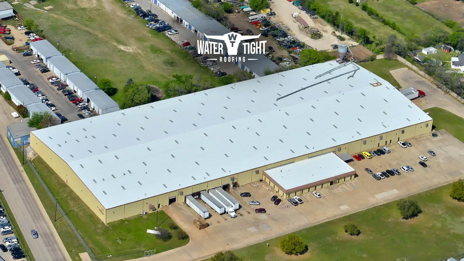 the true cost of delaying roof repairs why q1 is the best time to budget and plan Aerial view of a large white flat roof illustrating The Cost of Delaying Roof Repairs in Q1 and the value of budgeting and planning early.